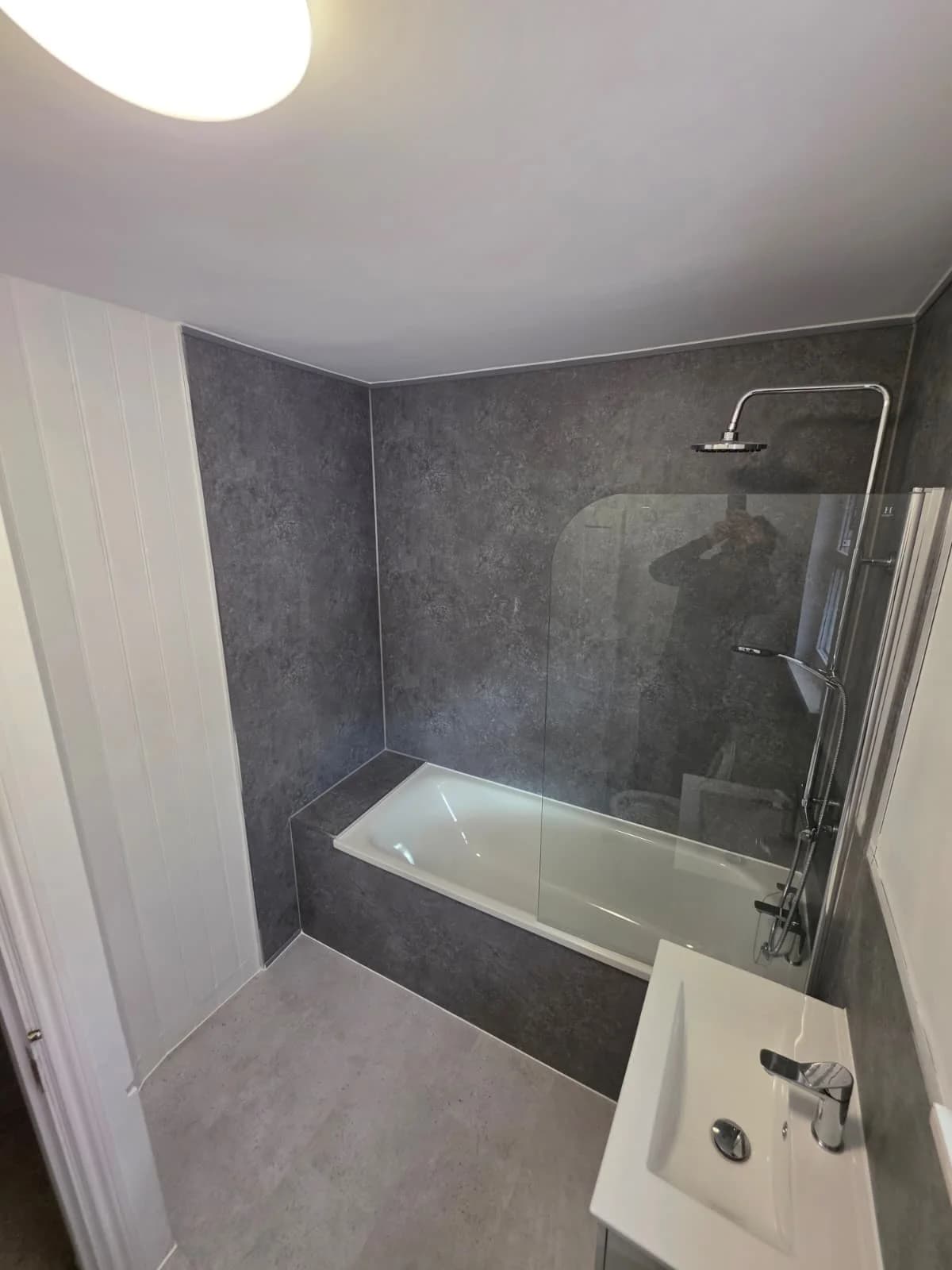 Grey tiled bath and shower with glass screen at Lancaster Road