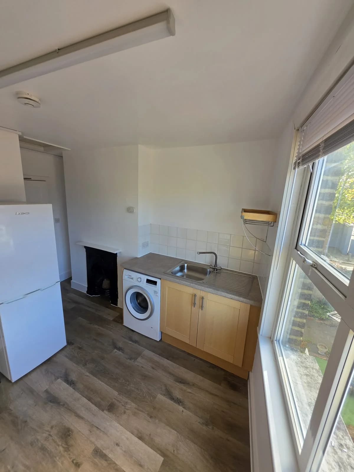 Kitchen at completion with timber-effect flooring at Lancaster Road
