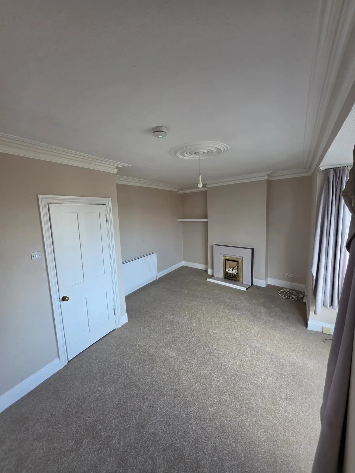 Living room with retained fireplace at Lancaster Road